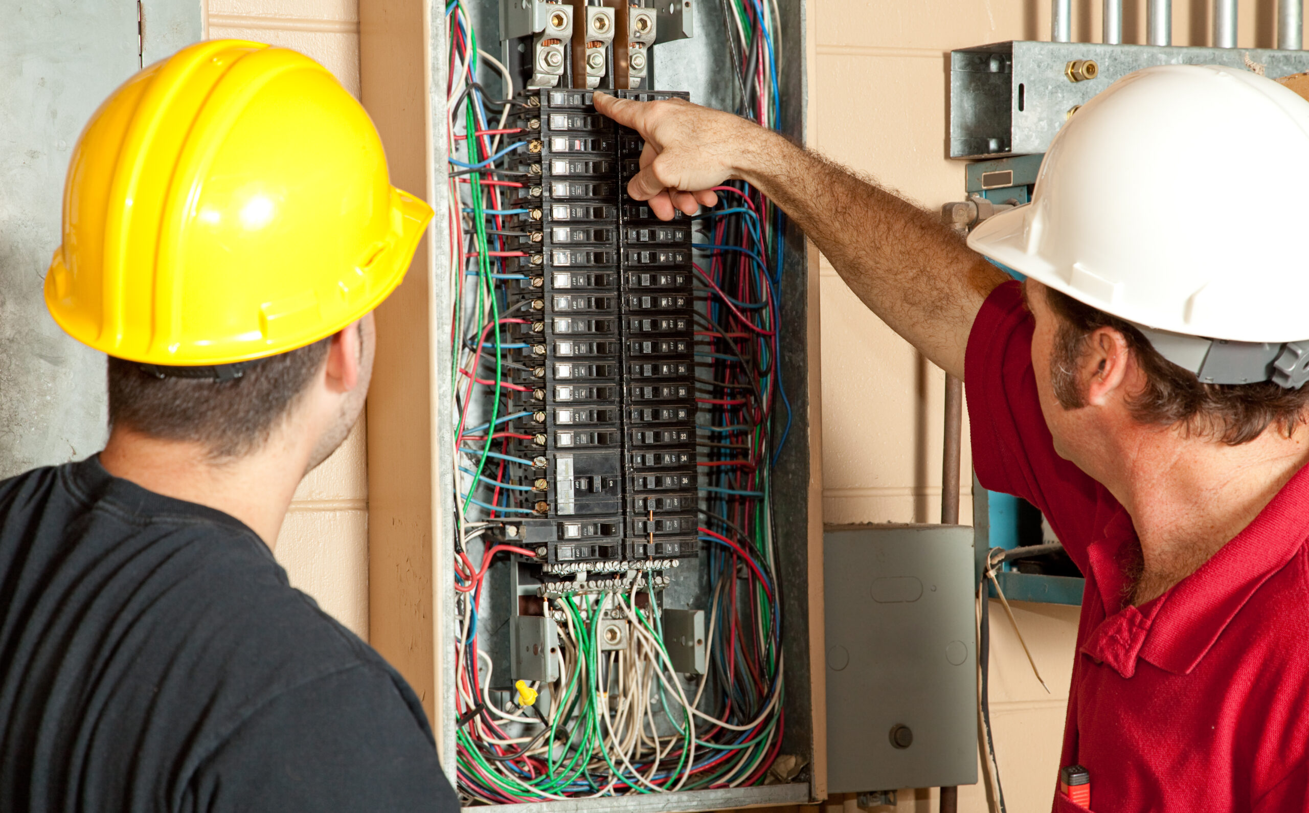 Electricians installing a new electrical panel